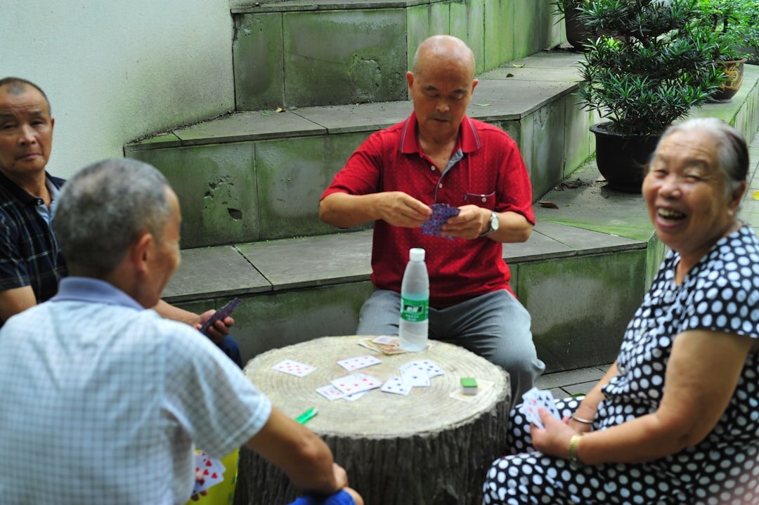 elderly people playing cards