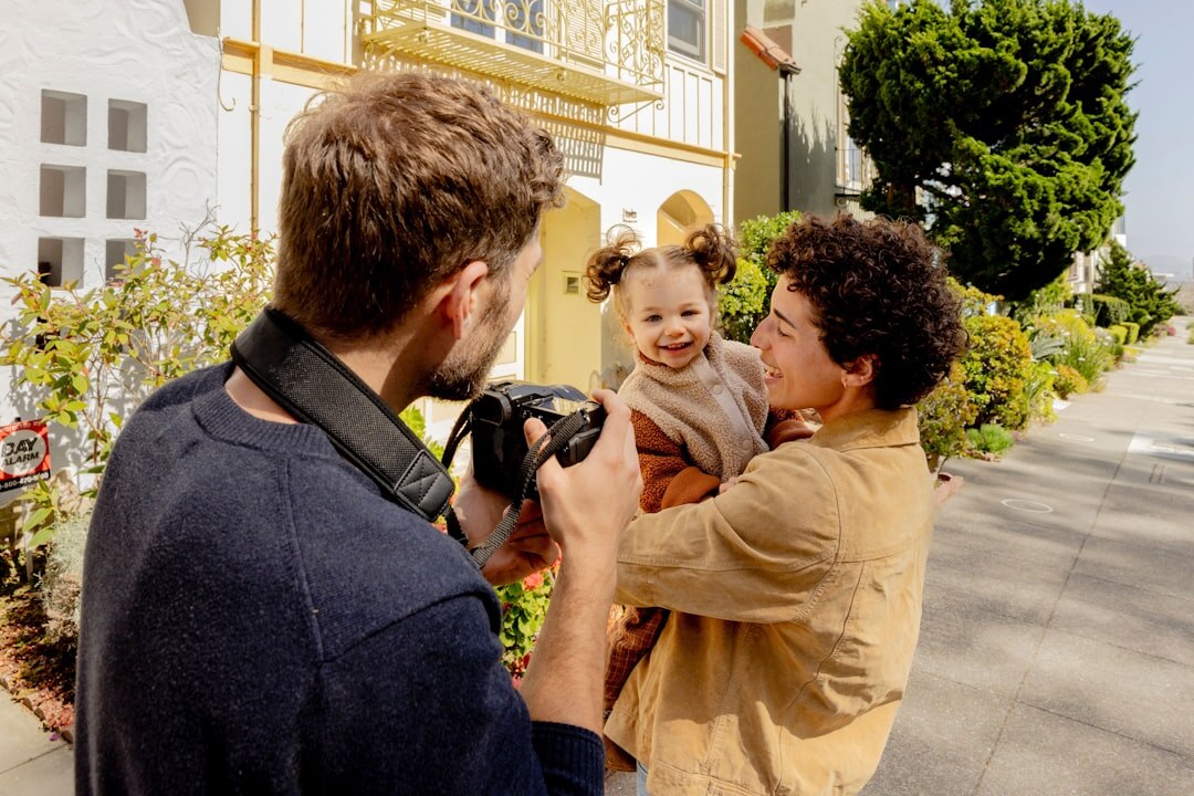 Photographer photographing a family outdoors during a session